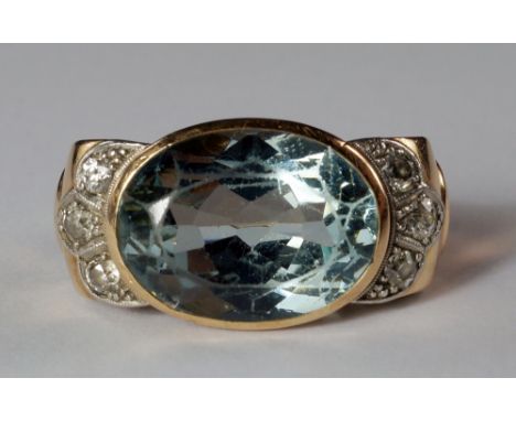 An impressive aquamarine and diamond dress ring, circa 1940s, mounted in unmarked yellow metal, the oval mixed cut natural aq