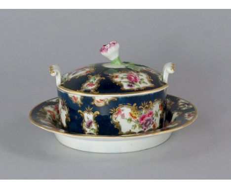 A Worcester porcelain butter tub, stand and cover, 18th century,  the lid with foliate finial, the body with scrolling shell 