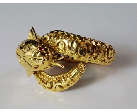 A 18ct gold snake ring, in the form of a cobra, with ruby chip eyes, pierced openwork scrolling design, approx size P, approx