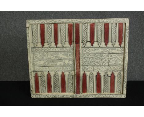 A vintage backgammon board in resin on a grp base, moulded to resemble bone and inlay. Decorated with fantastical beasts. Han