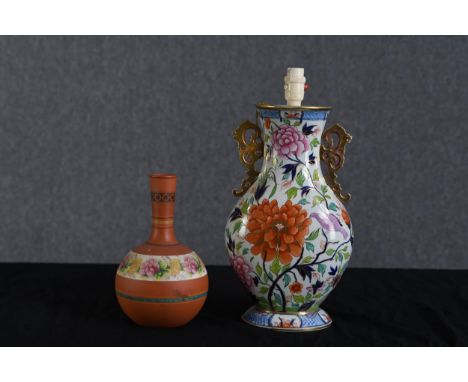 A  lamp and vase both in a floral decoration. Twentieth century. The lamp measures H.45 W.21 D.14 cm. 