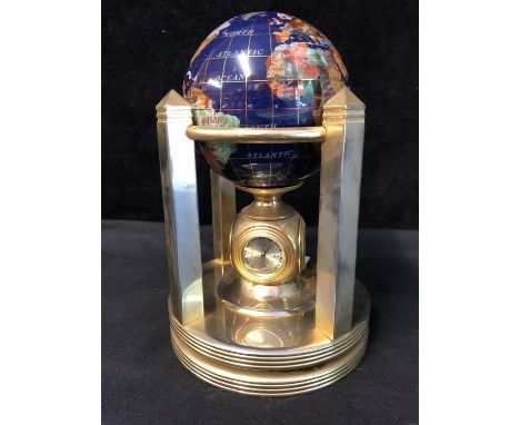 A small terrestrial globe, the countries picked out in faux semi precious stones, over a dials for two time zones, temperatur