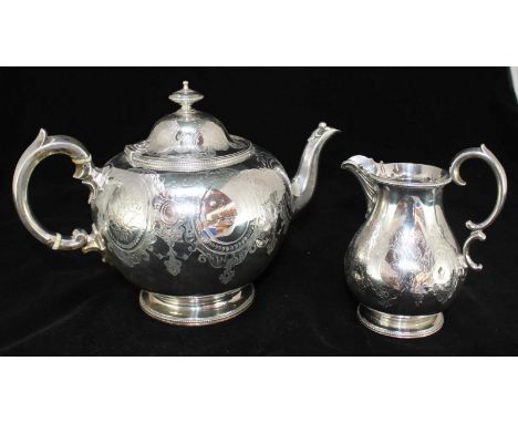 A Victorian silver teapot and matching cream jug, the teapot of globular form with finial and hinged dome cover, scroll handl