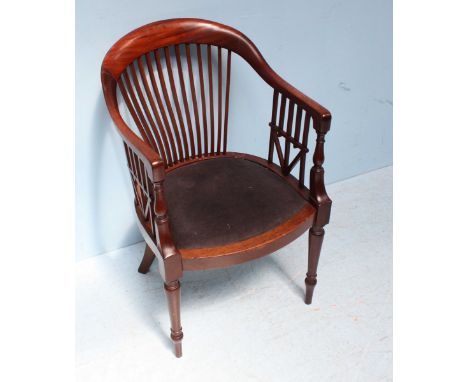 An early 20th century mahogany stick-back tub office armchair, with interesting inverted triangular feature to the sides, rai