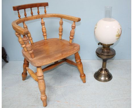 A brass oil lamp decorated with printed scenes of pheasants together with a child's captain chair.