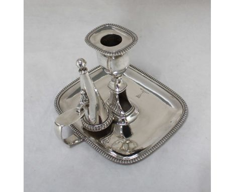 A George III silver chamberstick, with rectangular section candle sconce and pan with perpendicular reeded edge, separate con