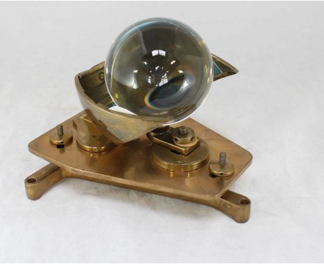 A 20th Century brass sun recorder, with spherical glass orb, brass fittings and mounted on tripod base. 18cm high.