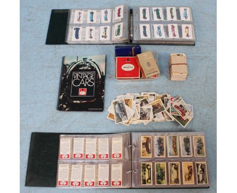 A selection of automobile-related cigarette cards, in two albums and some loose, also including four old cigarette boxes, inc