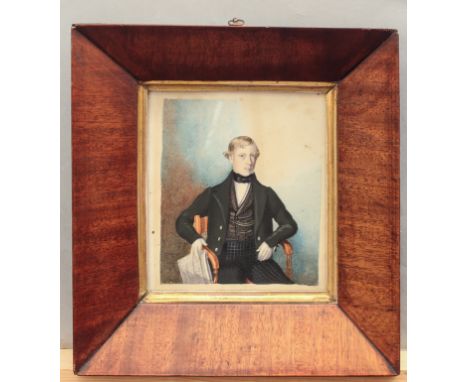 English School (19th century) A portrait of a young gentleman, seated in an elbow chair and holding a newspaper, dressed in a