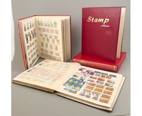 Four large stamp albums containing a wide range of stamps from Queen Victoria to Queen Elizabeth II, some in excellent condit