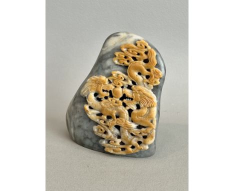 A Chinese soapstone mountain carving - second half 20th century, the grey marbled ochre and buff coloured stone carved with a
