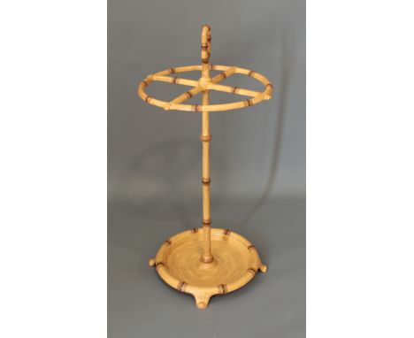 A painted cast iron faux-bamboo stick or umbrella stand - with top handle and circular tray base with bracket feet, 63cm high