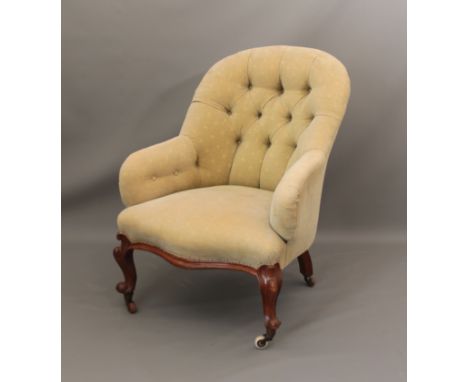 An upholstered button back armchair - 64.5cm wide, 93cm high.