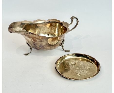 Two silver items - comprising a George V sauce boat, Mappin &amp; Webb, Sheffield 1924, with cut card rim, foliate capped scr