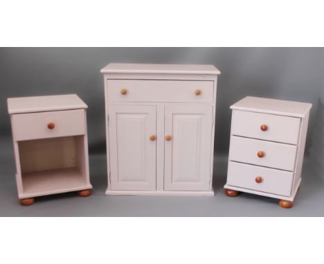 A painted pine cupboard (LWH 72 x 41 x 82cm) and a pair of bedside cabinets on bun feet (45 x 40 x 61cm). (3)