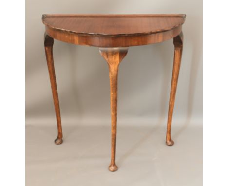 A reproduction mahogany demi lune side table - the top with piecrust edge, raised on turned beech legs with pad feet. (LWH 73