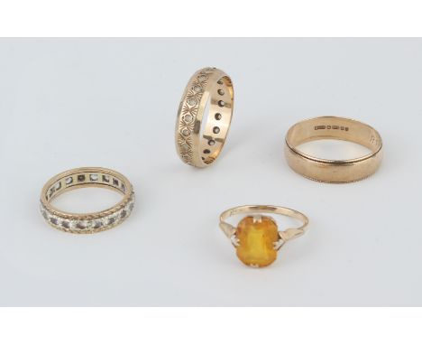 Four 9ct yellow gold rings - comprising a wedding band, London 1983, size Q; two eternity rings set with white stones (probab