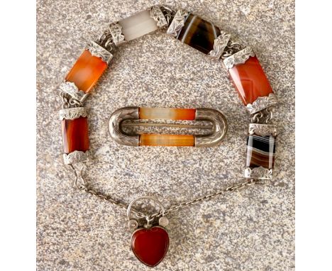 An early 20th century silver and agate mourning bracelet - the six agate bar links with foliate and floral chased mounts, eac