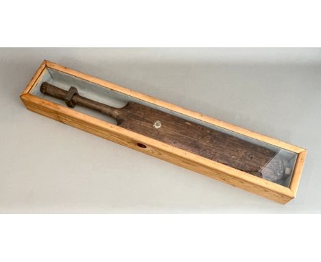 An old (possibly 19th century) cricket bat in a wooden glass-fronted case, 90 cm high.