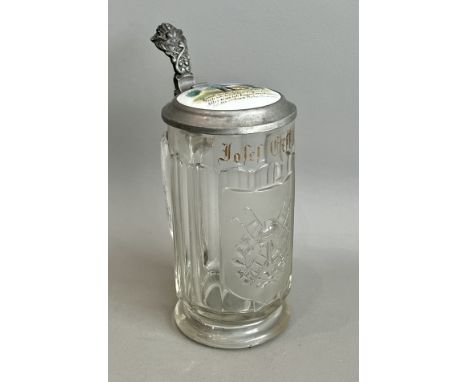 An unusual German erotic subject glass stein - early 20th century, the moulded glass stein with a part-frosted firefighter mo