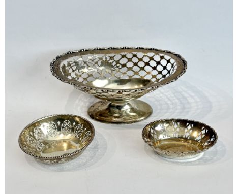 Three pierced silver dishes - comprising an Edwardian oval footed bon-bon dish, George Nathan &amp; Ridley Hayes, Chester 190