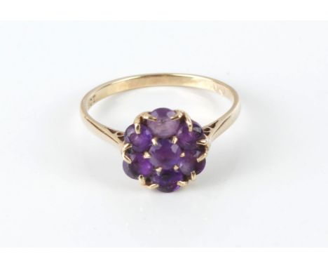 A vintage 9ct gold and amethyst cluster ring - hallmarked London 1965, with a cluster of seven round cut amethysts, size Q.