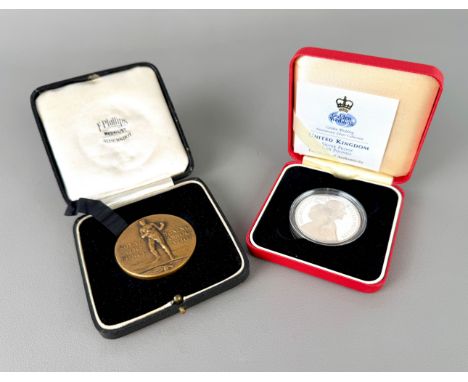 Two pieces: 1. a bronze Royal Air Force Boxing Association medal in its original box (Open Team Champions 1936-37 Middle Weig