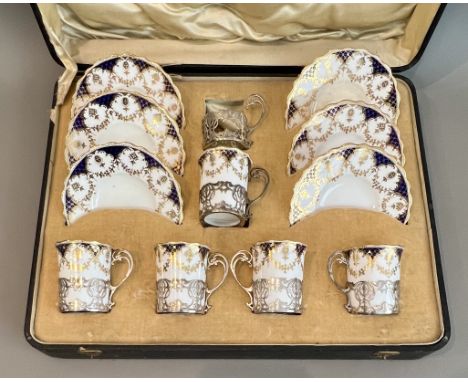 An Edwardian cased set of six silver mounted coffee cups and saucers - the mounts hallmarked Josiah Williams &amp; Co, London