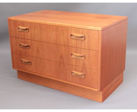 A G Plan teak low chest of drawers - the three graduated drawers with twin curling lip handles, raised on a platform base. (L