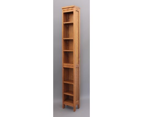 A modern blonde oak narrow bookcase - with five adjustable shelves and one fixed centre shelf. (LWH 24 x 19.5 x 168.5cm)