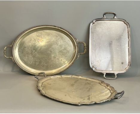 Three late 19th / early 20th century silver plated drinks trays - including a large oval tray with beaded rim and chased foli