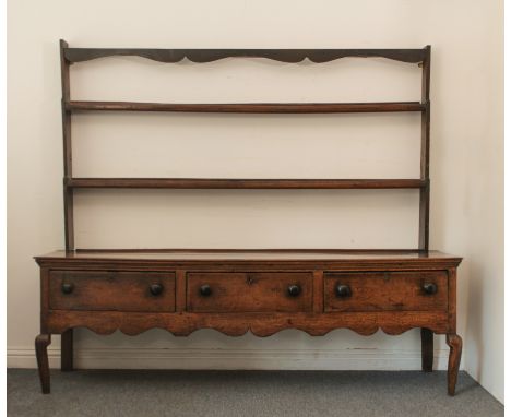 A George II oak dresser - with a matched top and base, the base reduced in height (feet removed), later turned wooden handles