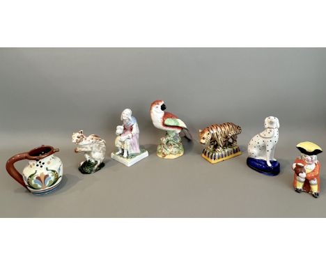 A small group of Staffordshire and other pottery - including an early 20th century figure of a parrot, black printed stamp 'S