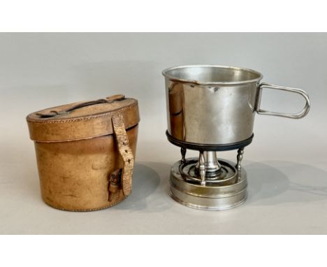 An early 20th century French leather cased campaign or travelling spirit stove with saucepan - the pan with folding handles, 