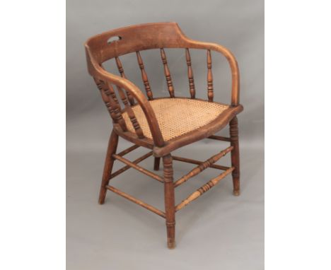 An early 20th century beech and ash smoker's bow-style chair with rattan seat - 59cm wide, 74cm high.