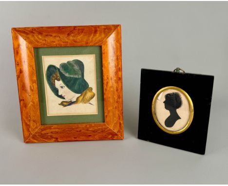 A framed silhouette of a lady on card, and a Victorian watercolour portrait of a lady in a bonnet in a maple frame.