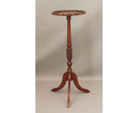 A reproduction mahogany tripod torchere with piecrust top - 34cm diameter, 90.5cm high.