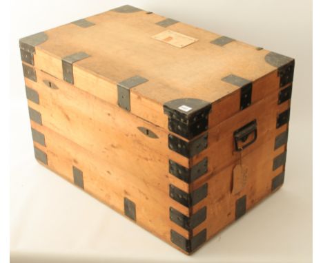 An early 20th century pine, plywood and steel-bound trunk - (LWH 76 x 48 x 49cm), old (inactive) worm to one side of lid.