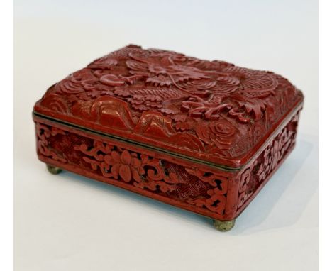 A Chinese cinnabar lacquer box - probably first half 20th century, rectangular form, the hinged lid decorated with a dragon a