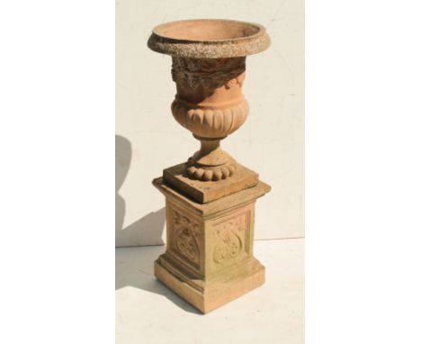 A reconstituted stone urn planter and stand, 42cm diameter, 100.5cm high.