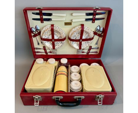 A vintage 1950s Brexton picnic set - for four persons, in red and cream, near complete (lacks one saucer, one additional cup 