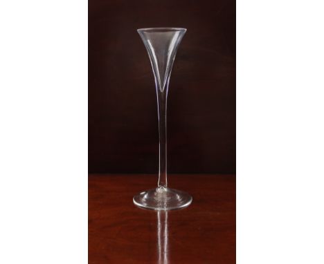 A mid-18th century tall toasting or toastmaster's glass - circa 1750, the flared, drawn trumpet bowl on a slender, plain stem