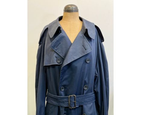 A vintage 1980s gentleman's Aquascutum trench coat - navy blue, size 44. Fading and wear to the collar and edges of lapels, w