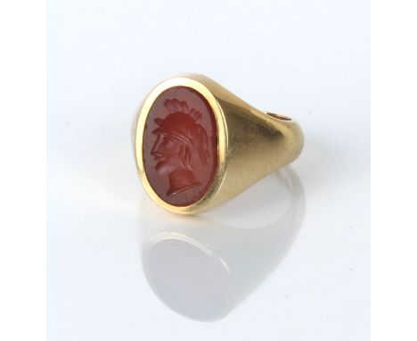 An 18ct gold intaglio signet ring, the oval hardstone engraved with the head of a hoplite, size H/I, gross weight 8.1g&nbsp;