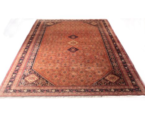 A Persian Kashkouli hand-knotted wool carpet - late 20th century, with three dark-blue and ivory lozenge medallions on a bric