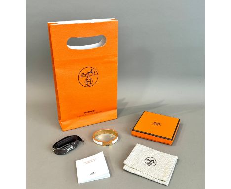 An Hermes Le Bracelet 'Mini Clic' - with stamped and etched maker's marks, gold plated with white enamel accents, the hinged 