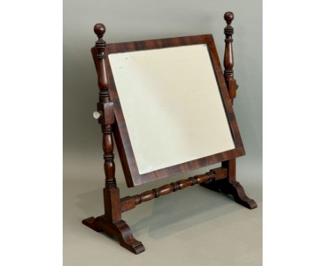 A small early 19th century mahogany toilet mirror - the rectangular plate on turned uprights with pawn finials, on sledge sup