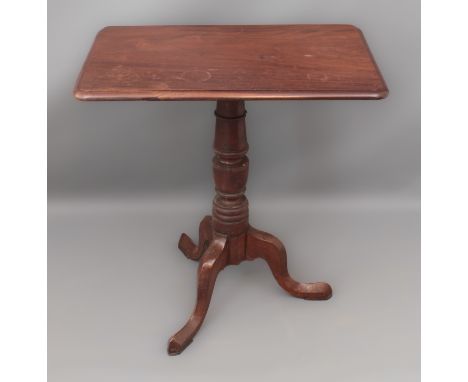 A mid-19th century mahogany tilt-top tripod table - the moulded, rectangular top on a turned column to three bevelled swept s