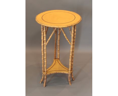 A Victorian style bamboo and painted lamp table - the circular top with detachable glass, raised on twinned bamboo supports w