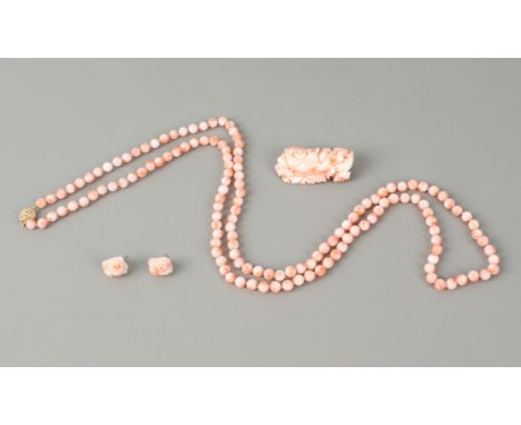 A suite of angel skin coral jewellery - comprising a floral carved brooch with a gold plated frame, 4.6cm long; a pair of mat